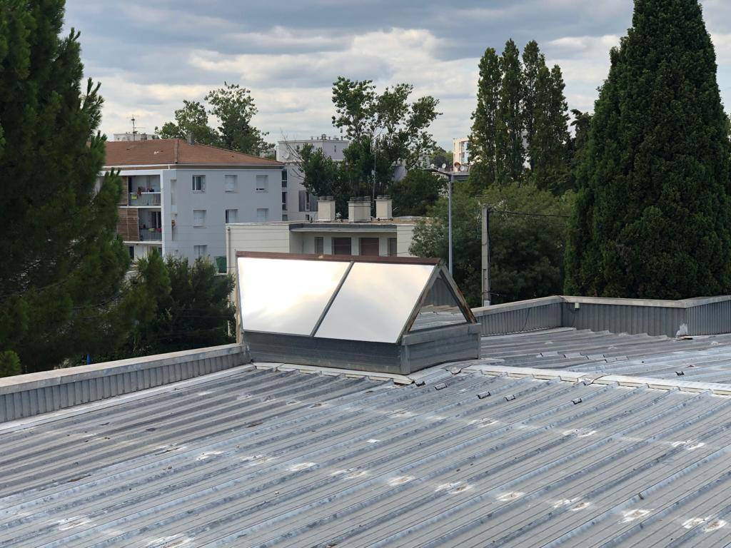 Isolation avec film adhésif solaire du toit en verre du gymnase de Montpellier